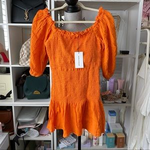 Orange smocked puff sleeve dress